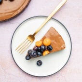 vegan chocolate mousse cake sliced on white plate with spoon